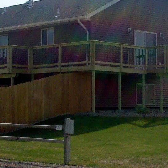 wrap around wood deck with metal spindles