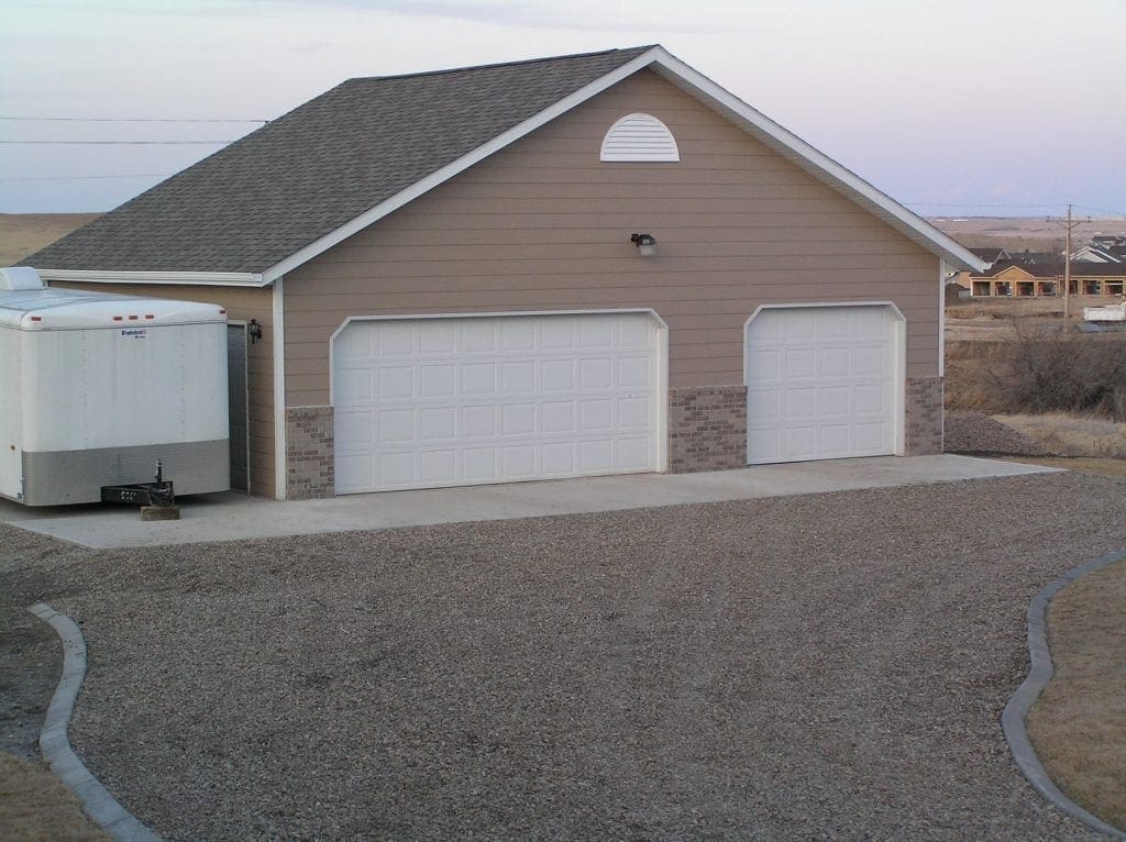 detached three car garage with concrete pad